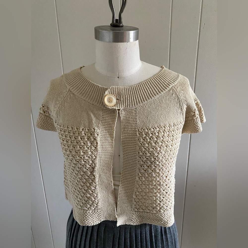Cropped pointelle cardigan with bead encrusted button closure.